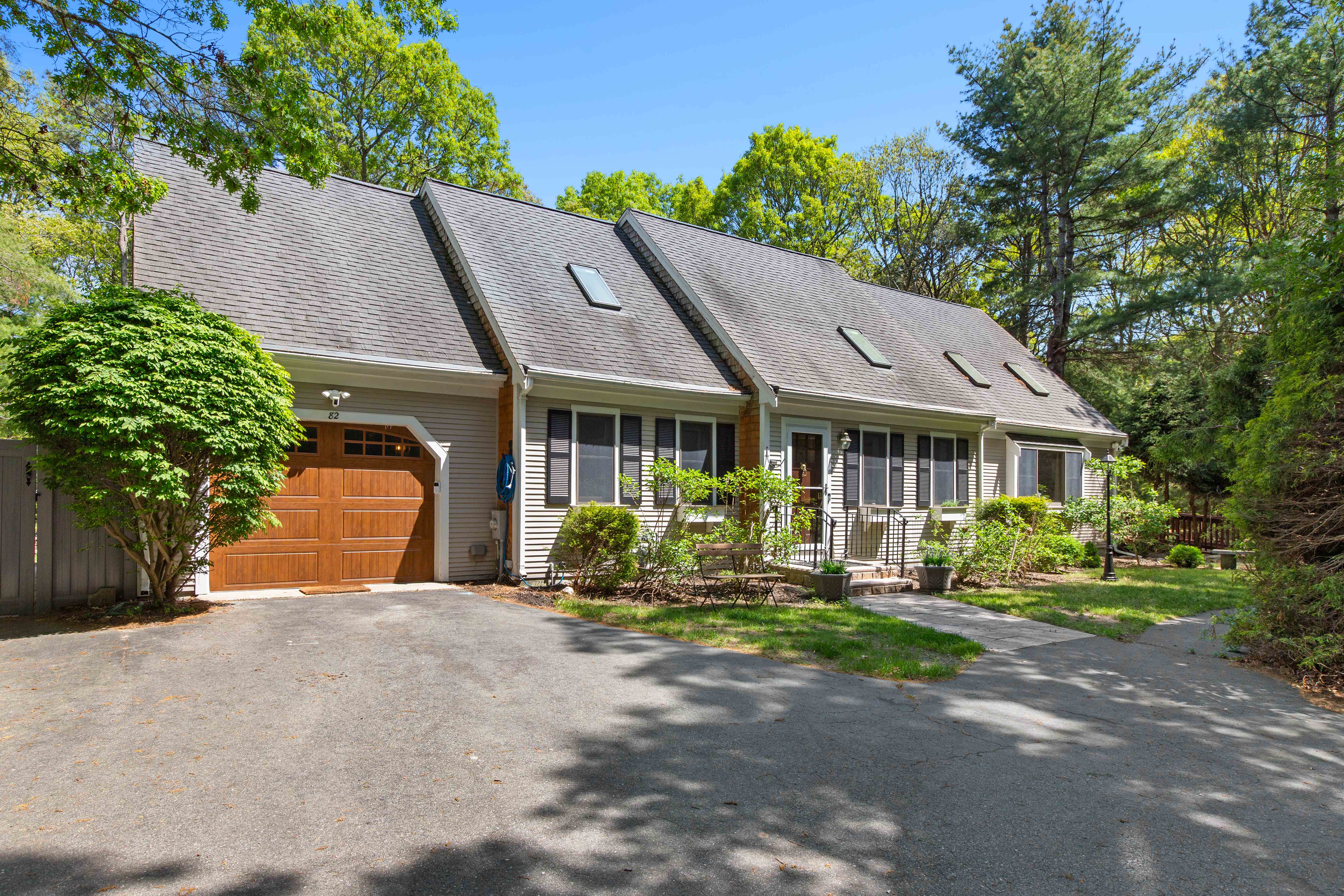 Front three-quarter view of the home showing the garage, entry, gables, and skylights