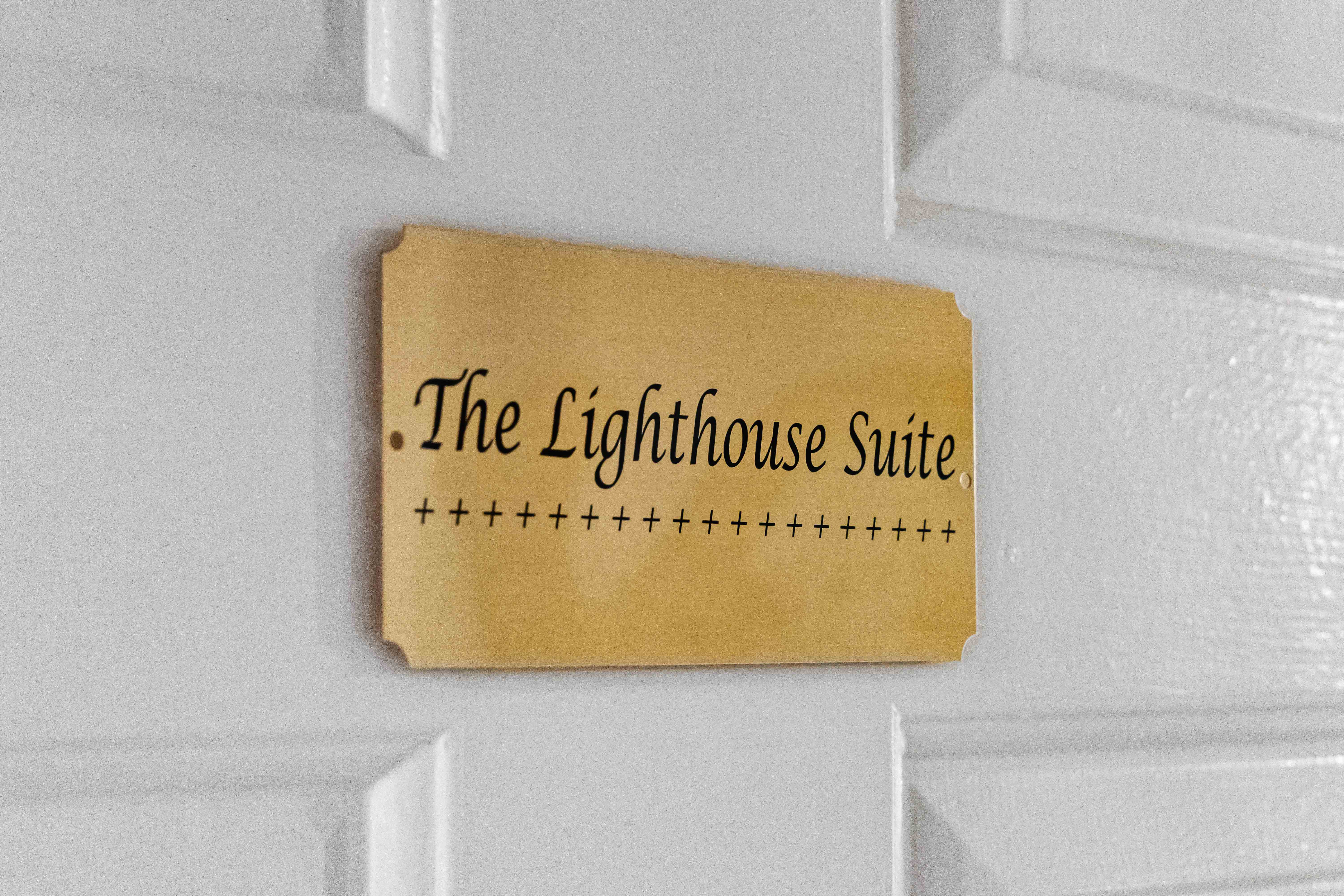 Brass door plaque engraved "The Lighthouse Suite"