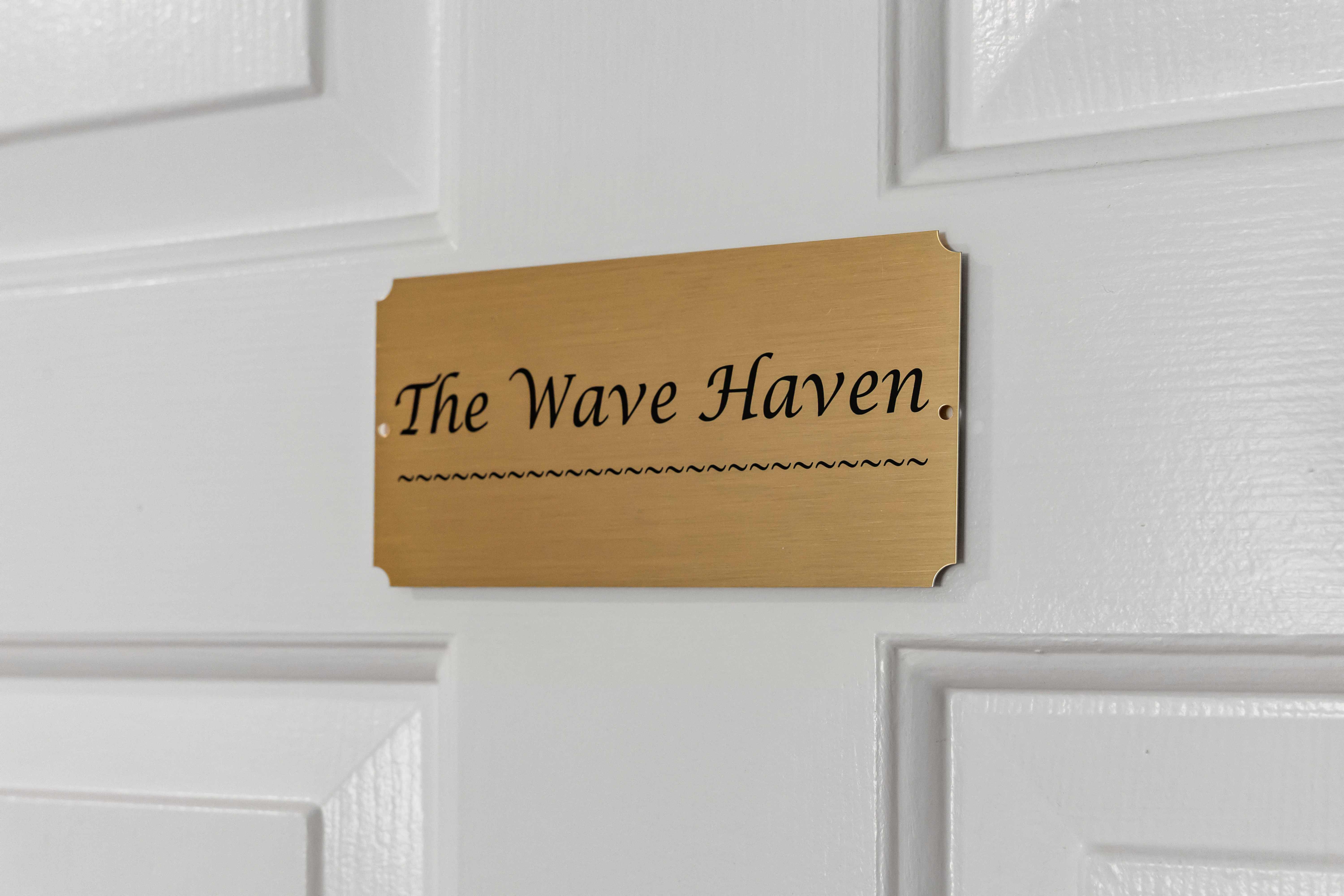 Brass door plaque engraved "The Wave Haven"